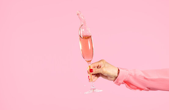 Splash: Woman Holding Splashing Pink Champagne 