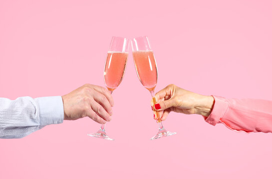Woman and Man Toasting with Flutes of Pink Champagne 