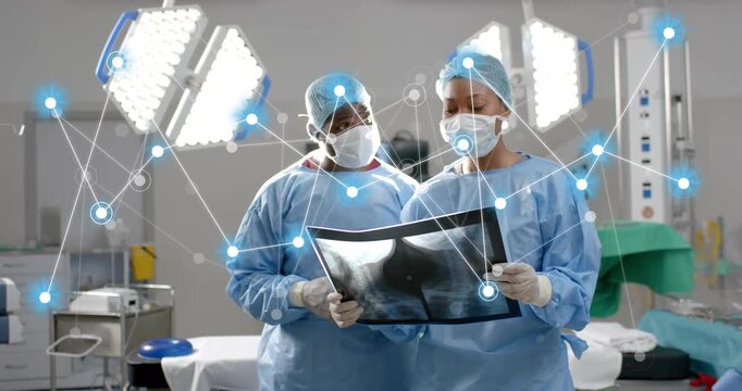Surgeon duo inspecting X-ray upon digital network appearing under lights for medical guidance - Powered by Adobe