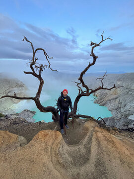 Hiker standing over volcanic crater lake