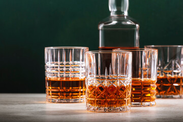 Irish blended whiskey n glass with bottle on dark green background