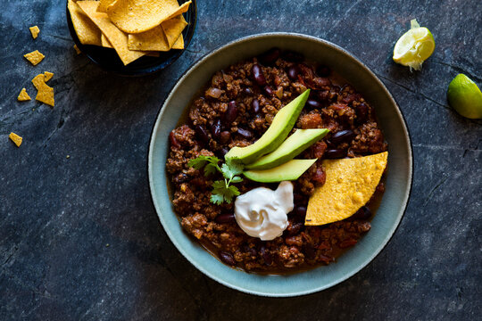 Beef chili with avocado, sour cream and tortilla chips