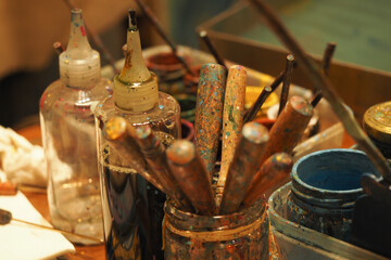 Art supplies arranged on a table in a creative workspace