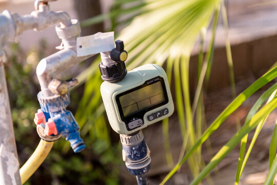 Outdoor Faucet With water Timer Attached to Garden Hose