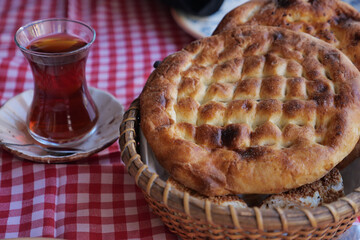 Traditional turkish bread and tea on a checkered tablecloth