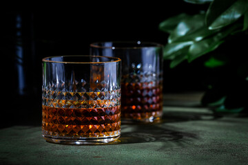 Japanese blended whiskey in glass. Dusk green background, elegant night decoration