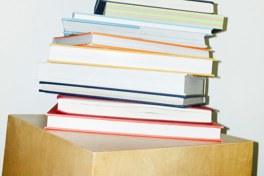 Pile of books and colourful drawing pencils in work office environment - Powered by Adobe