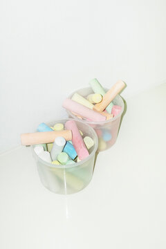 Box of colourful art artsy drawing chalks with hard direct flashlight
