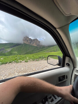 View from car window toward rocky mountains