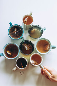 Assorted Teacups in a Circle with a Hand Reaching In