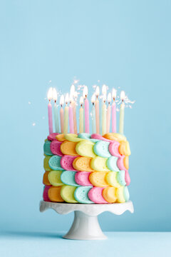 Rainbow petal cake with pastel birthday candles