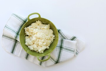 Homemade cottage cheese in a sieve, free space, calcium, diet, top view