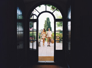 Tourists arriving at hotel, walking through doorway