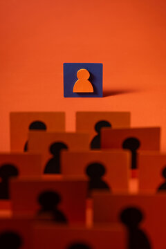 Conceptual image of a leader standing out among a team