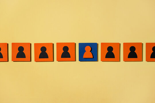 Colorful blocks depict teamwork and leadership on yellow background