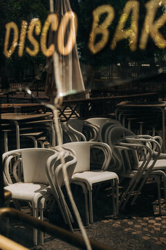 Stacked chairs reflected in disco bar window