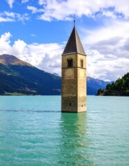 Tower in a lake under a blue sky