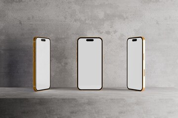 Three smartphones with blank screens on concrete platform