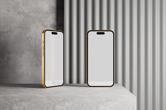 Two smartphones with blank screens on concrete platform