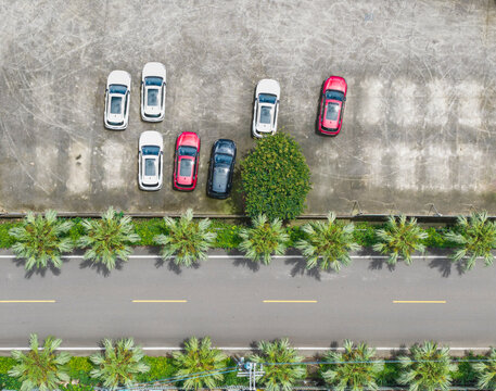 Aerial View of Car Dealership Parking Lot with Cars Near Road an