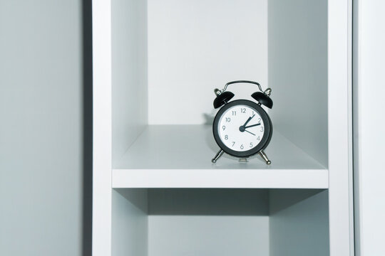 Classic Black Alarm Clock on a Minimalist White Shelf