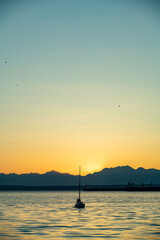 Sunset over the Puget Sound in Seattle, Washington at the Pikes Place Pier. Sun setting over the...
