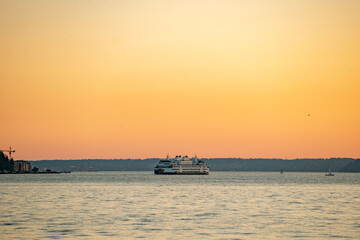 Sunset over the Puget Sound in Seattle, Washington at the Pikes Place Pier. Sun setting over the...