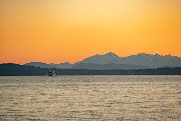 Sunset over the Puget Sound in Seattle, Washington at the Pikes Place Pier. Sun setting over the...