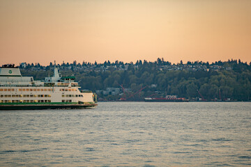 Sunset over the Puget Sound in Seattle, Washington at the Pikes Place Pier. Sun setting over the...