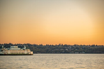 Sunset over the Puget Sound in Seattle, Washington at the Pikes Place Pier. Sun setting over the...