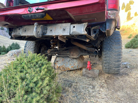 Off-road vehicle lifted on rock in mountains