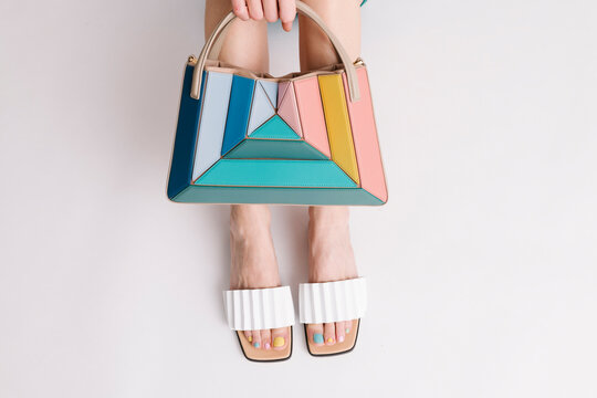Stylish Multicolored Handbag and Sandal Combination Against Whit