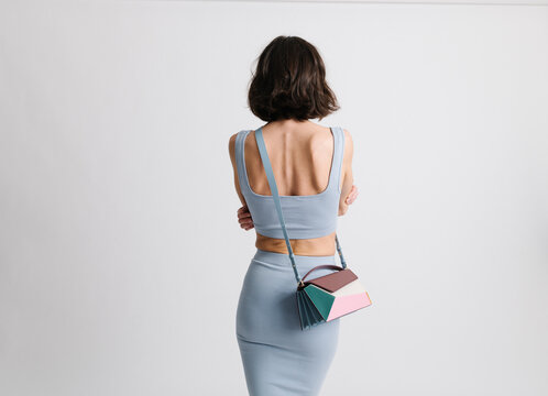 Back View of Stylish Individual Carrying Colorful Handbag in Mod