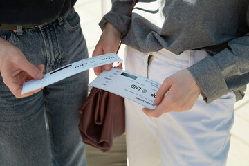 Tourists holding airplane tickets before departure