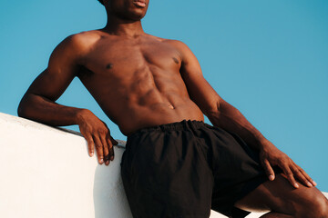 Unrecognisable athletic young black man with fit abs and torso 