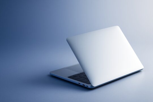 Minimalist silver laptop partially open on blue background with soft lighting, showcasing elegant tech design and clean copyspace concept template. Ai generative