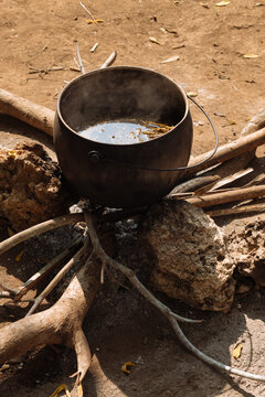 Boiling Herbs in a Traditional Pot Over an Open Fire