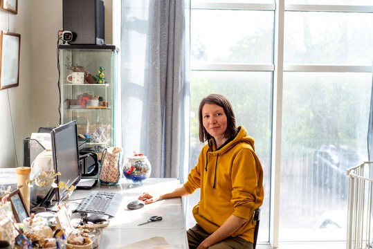Young female artist at her work table in her studio