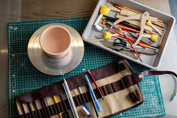 Top view of tools, brushes and materials in an artist's workshop