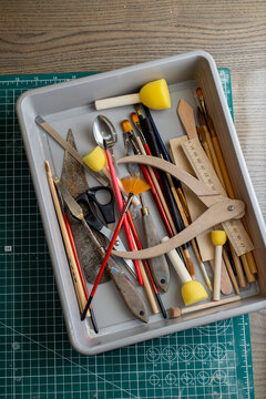 Top view of tools, brushes and materials in an artist's workshop