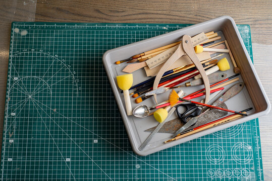 Top view of tools, brushes and materials in an artist's workshop