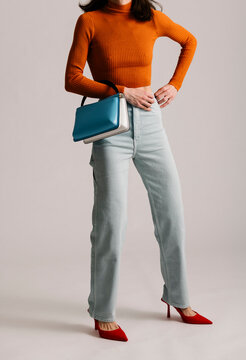 Fashionable Outfit Featuring a Vibrant Sweater, Jeans, Shoes, an
