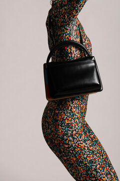 Stylish Black Handbag Displayed with Vibrant Floral Outfit