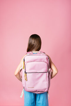 Back view of a student girl with a pink Backpack