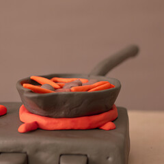 Playful clay frying pan with carrots on stove in artistic cooking scene 