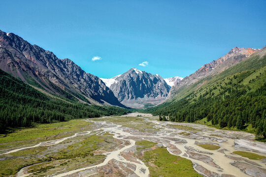Aerial view of alpine valley and river delta