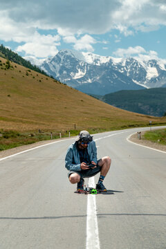 FPV drone pilot setting up on mountain road