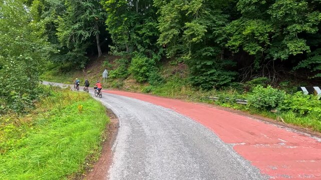 Cyclists Climbing Forest Road in Cromarty, Scotland
