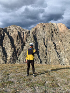Man holding drone in mountain landscape