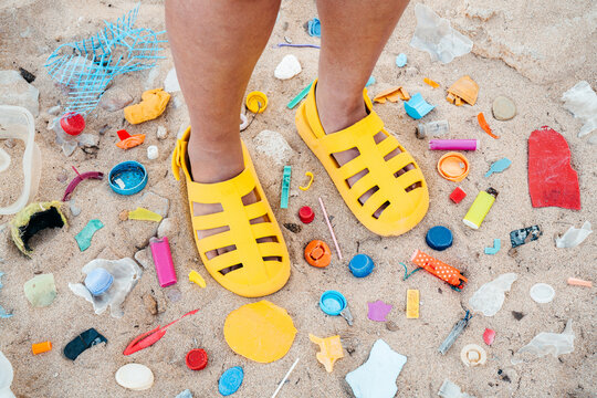 Colorful Sandals on a Beach Littered With Plastic Waste
